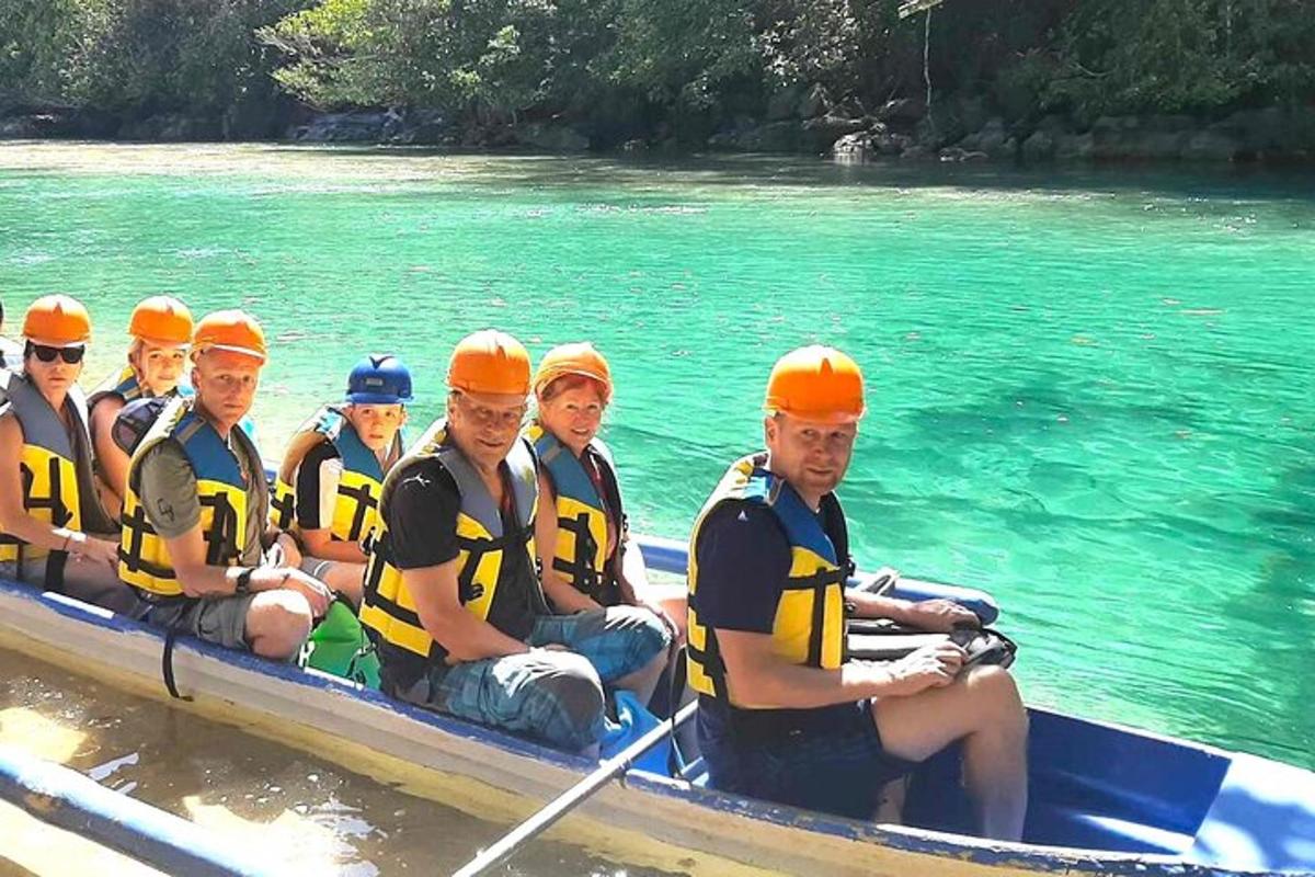 a group of people in a boat on the water