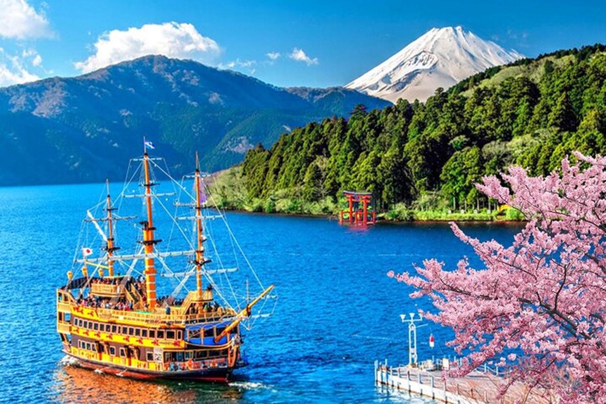 a boat on a lake with a mountain in the background