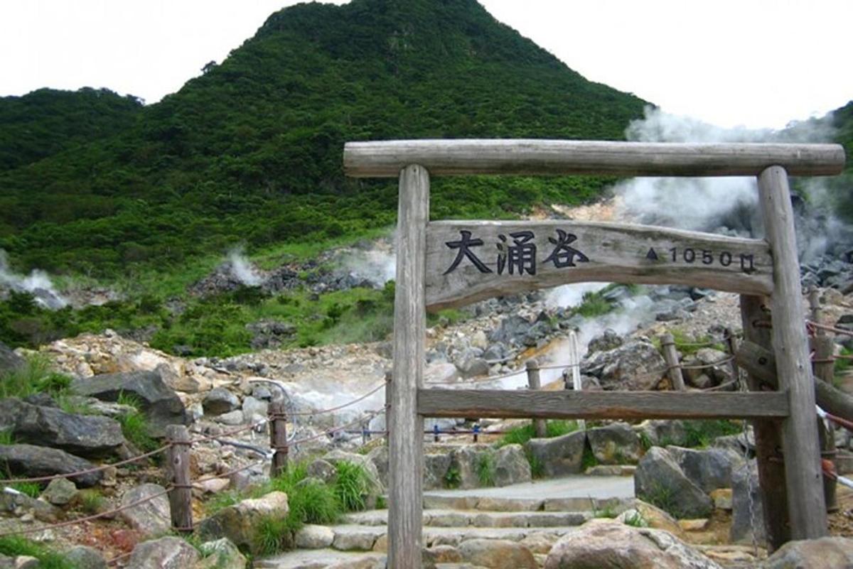 a sign with people walking on a mountain