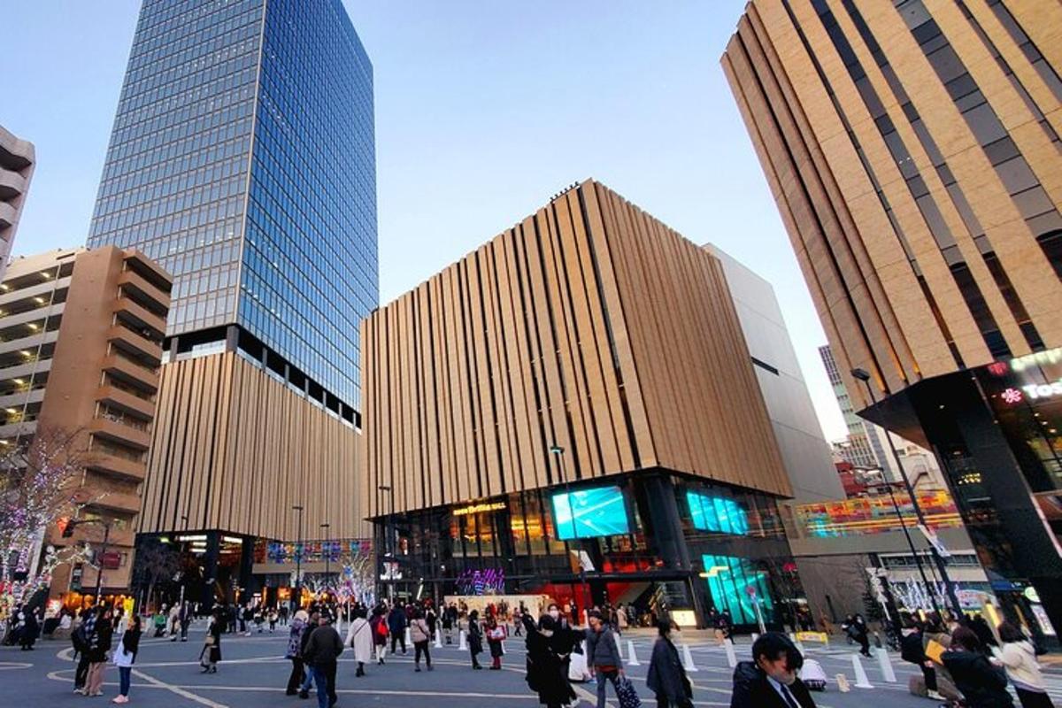 un grup de persones caminant per una ciutat amb edificis alts