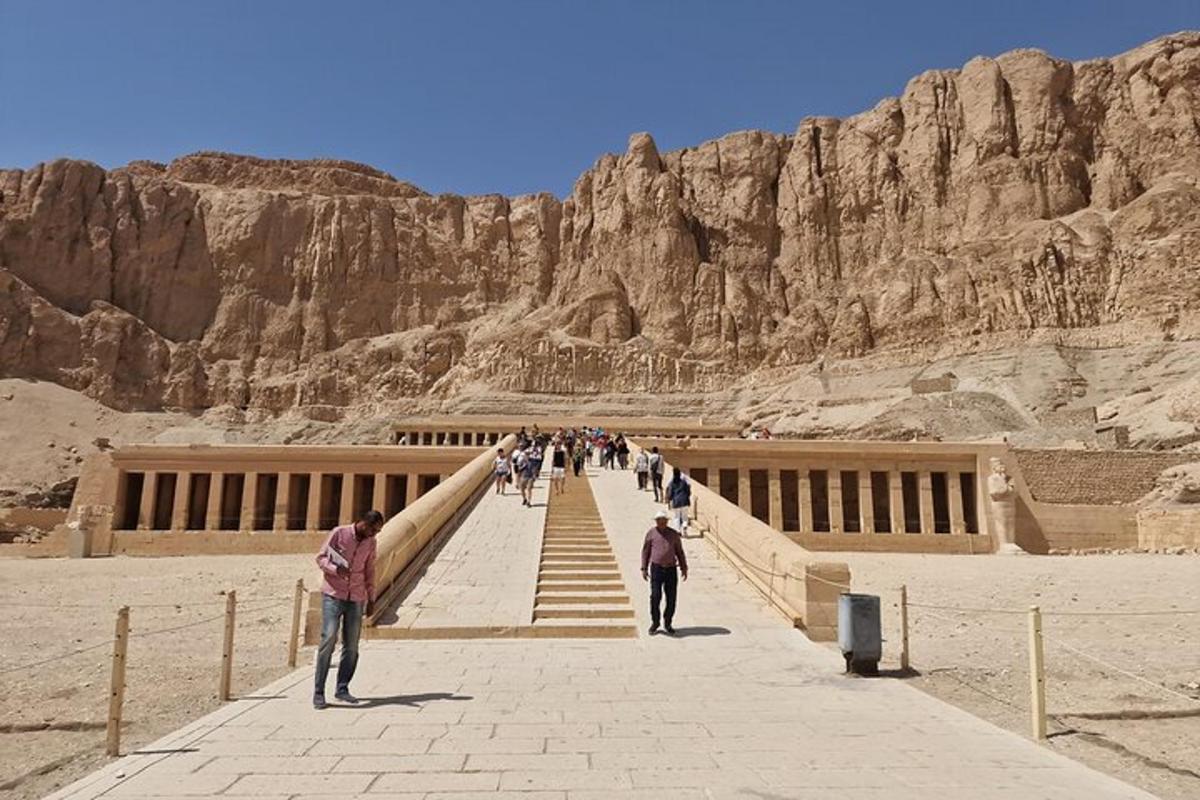 a group of people walking up a staircase in the desert