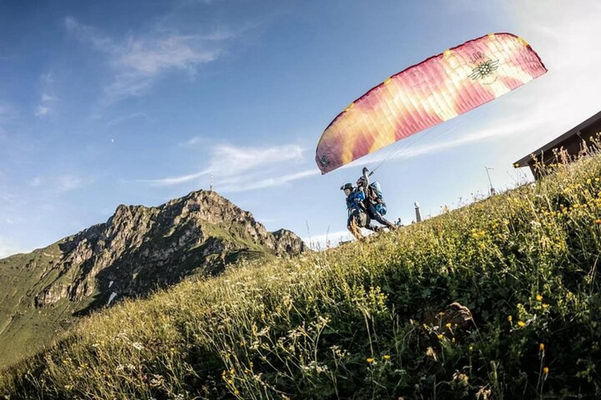 eine Person, die auf einem Hügel mit einem Fallschirm fliegt