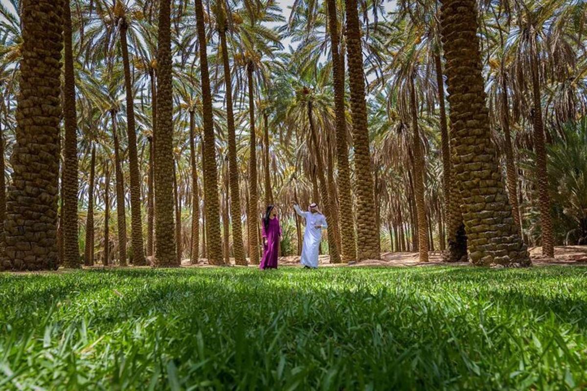 a man and woman standing in front of palm trees