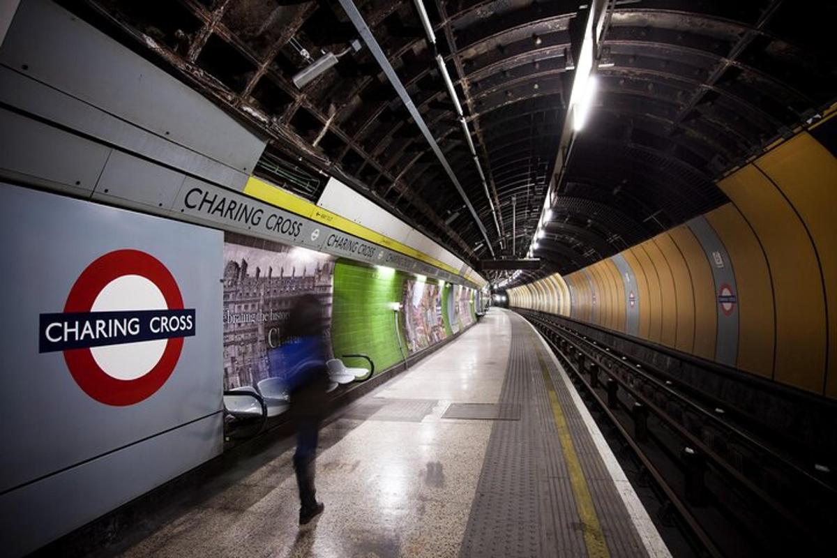 a subway tunnel with a person walking on the subway