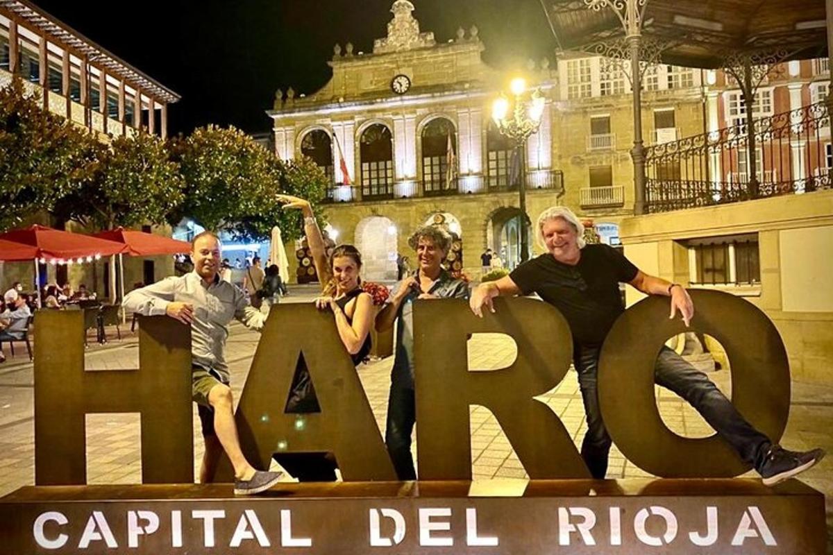 a group of people sitting on top of a sign