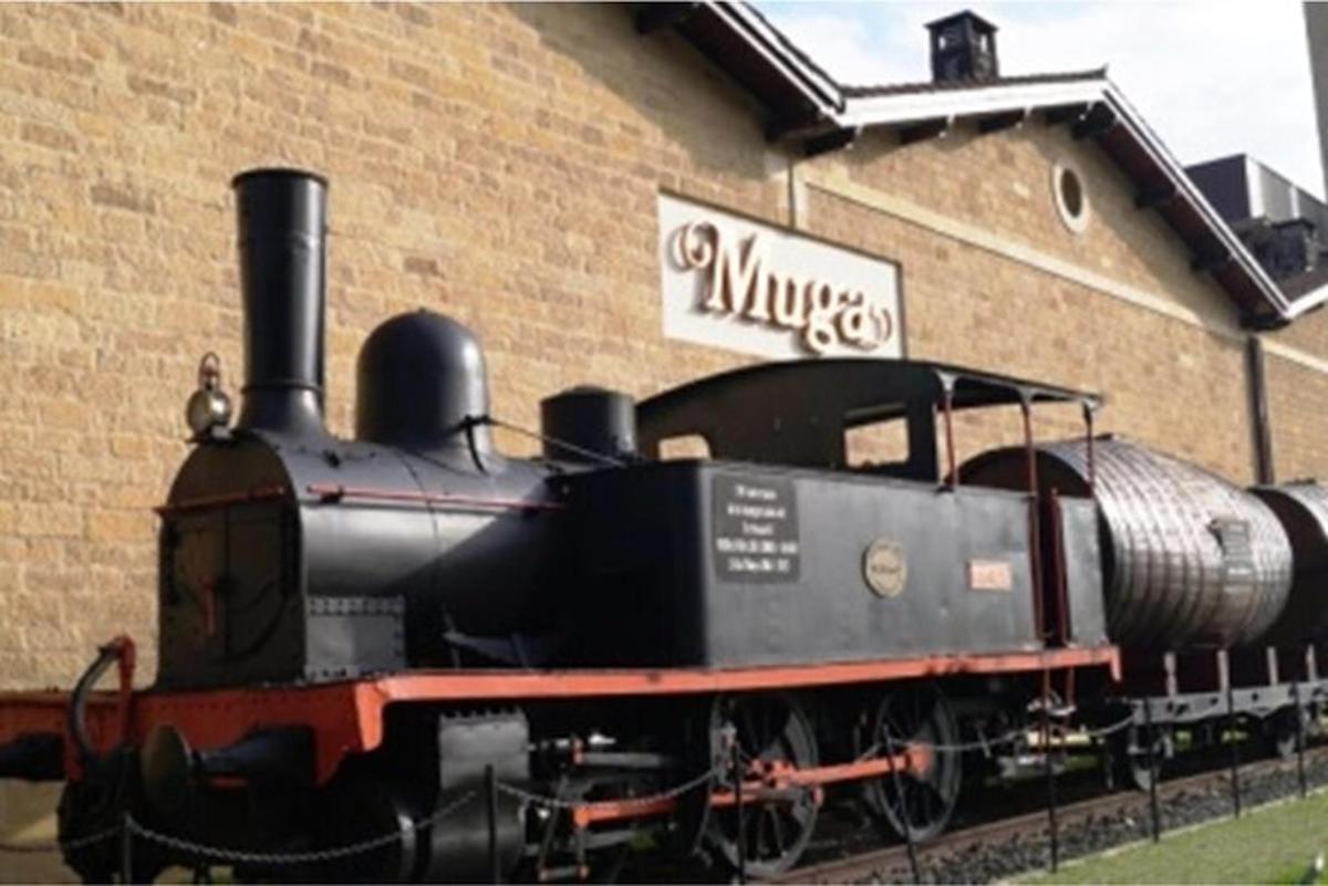 a black train sitting in front of a building