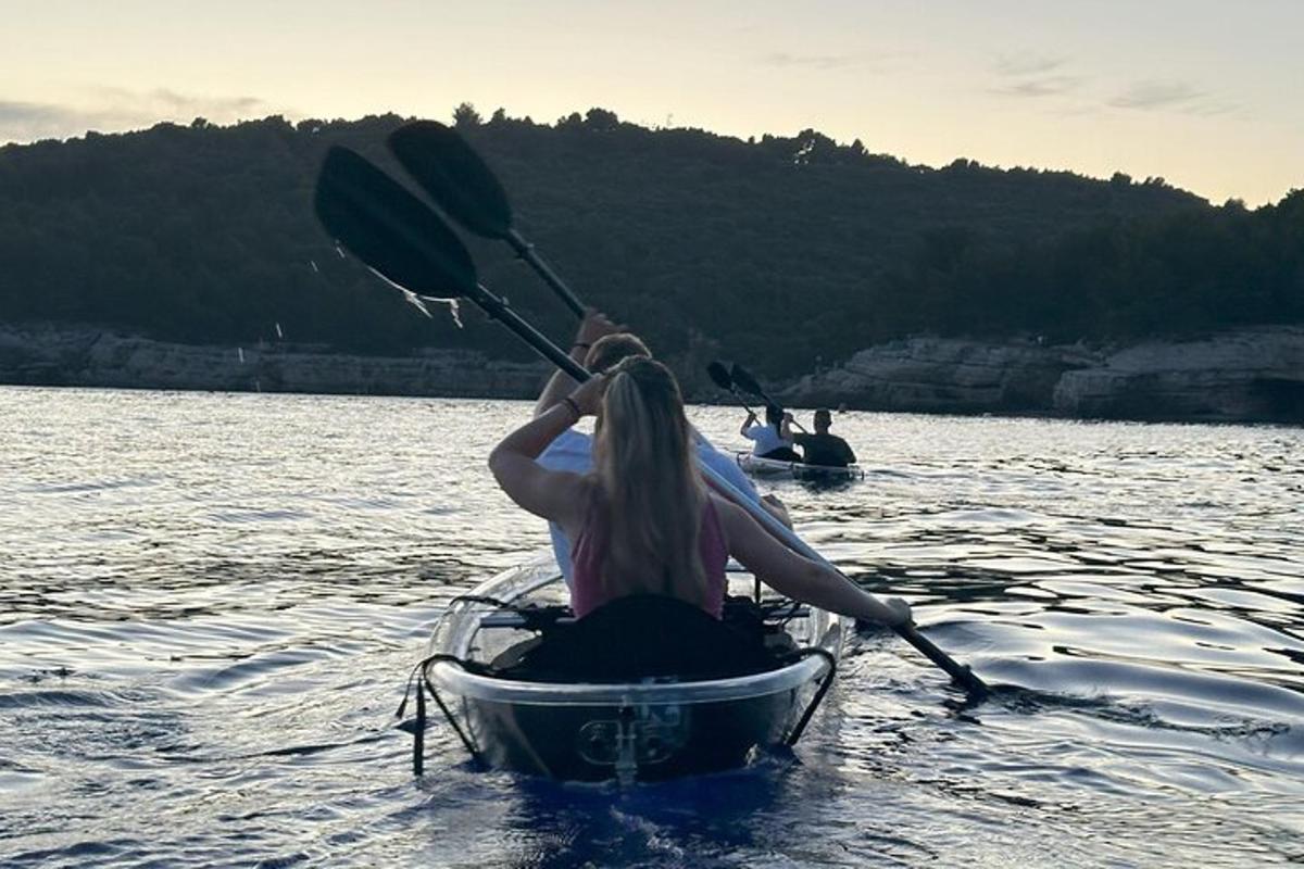 a woman is rowing a boat on the water