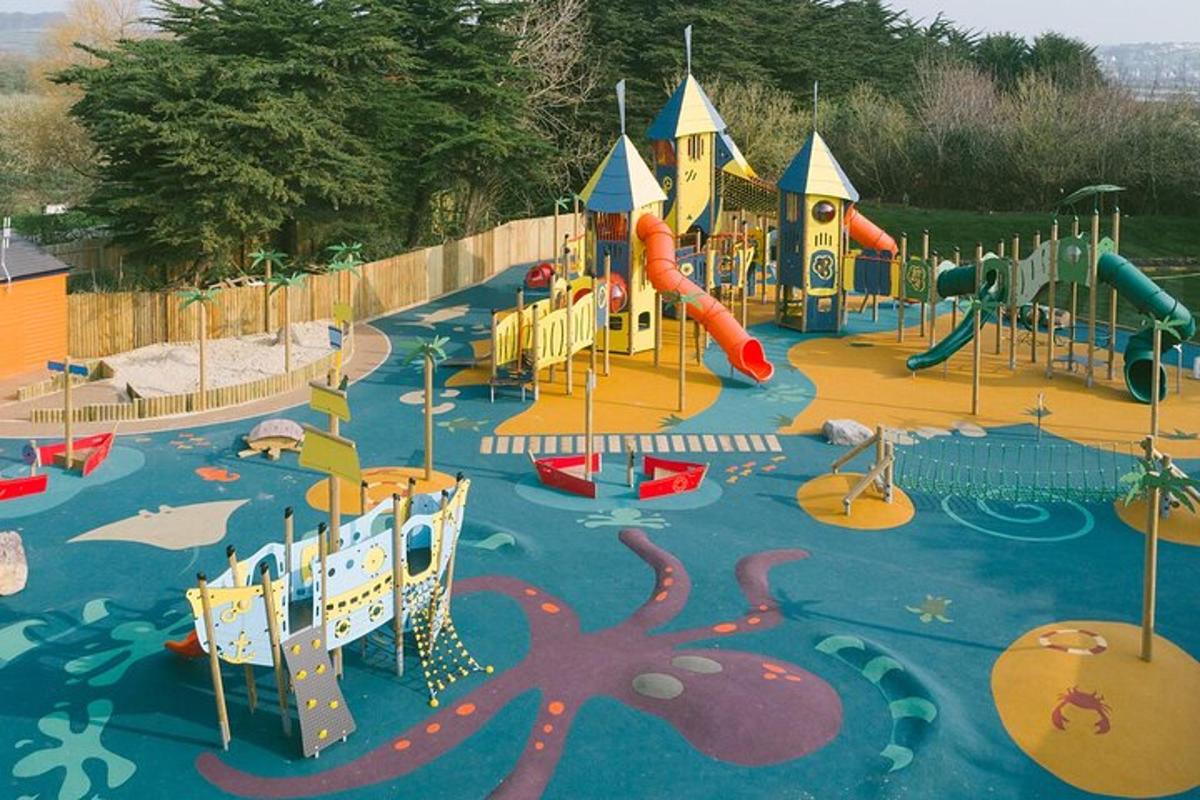 a playground with a water park with slides and an octopus