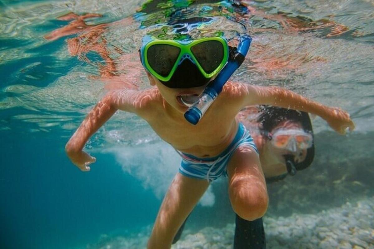 ゴーグルをつけて水中で泳ぐ少年