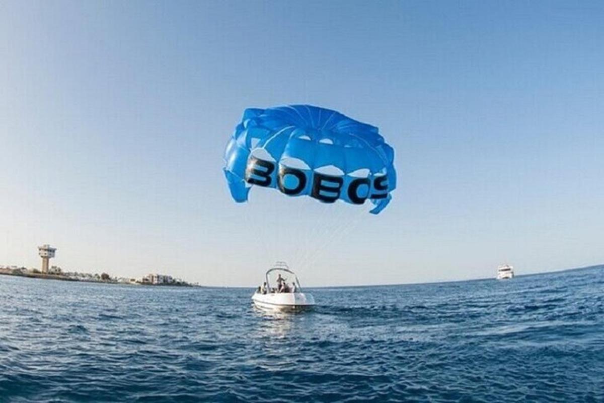 a kite flying over a boat in the water