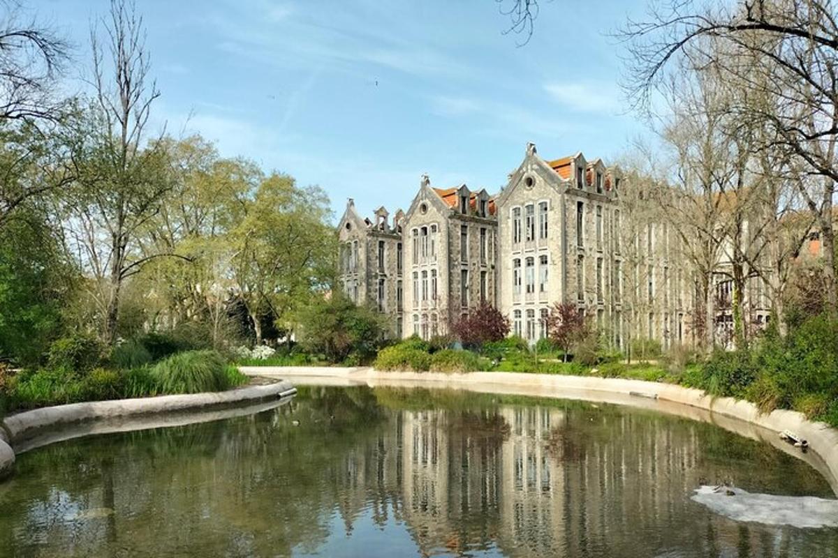 a large building with a pond in front of it