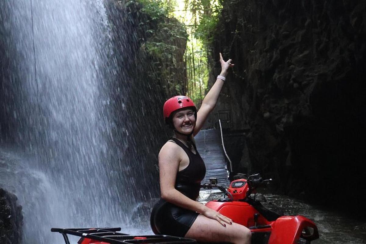 una donna in moto davanti a una cascata