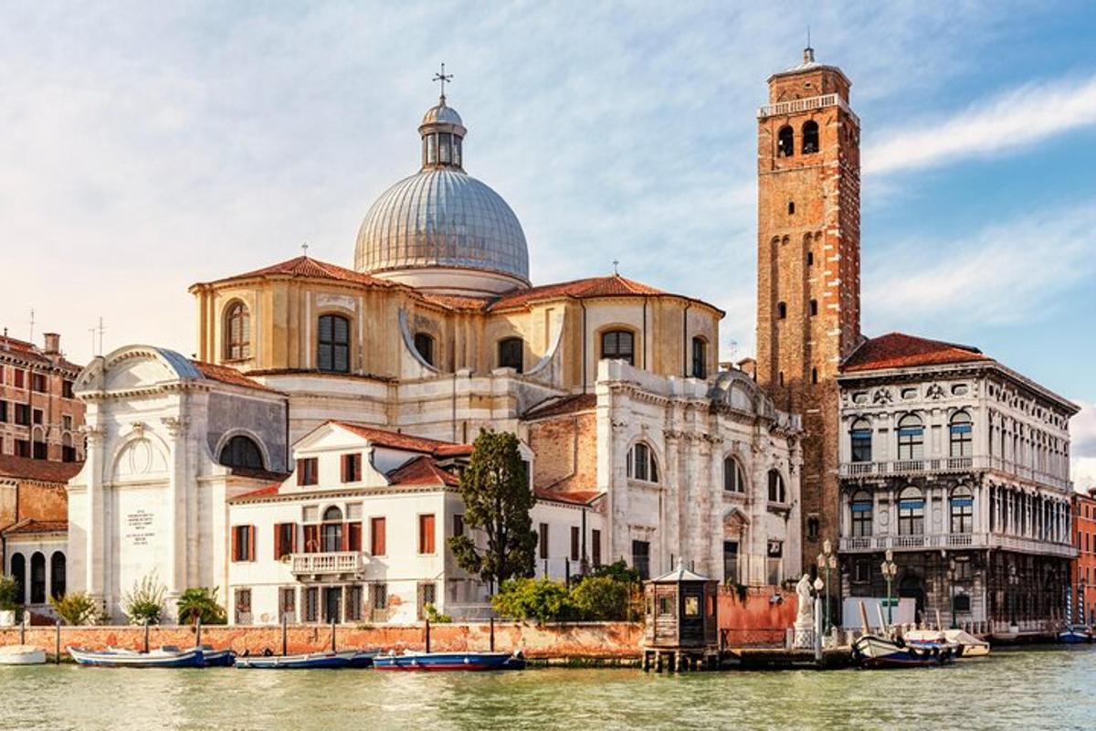 a large building with a clock tower next to a river
