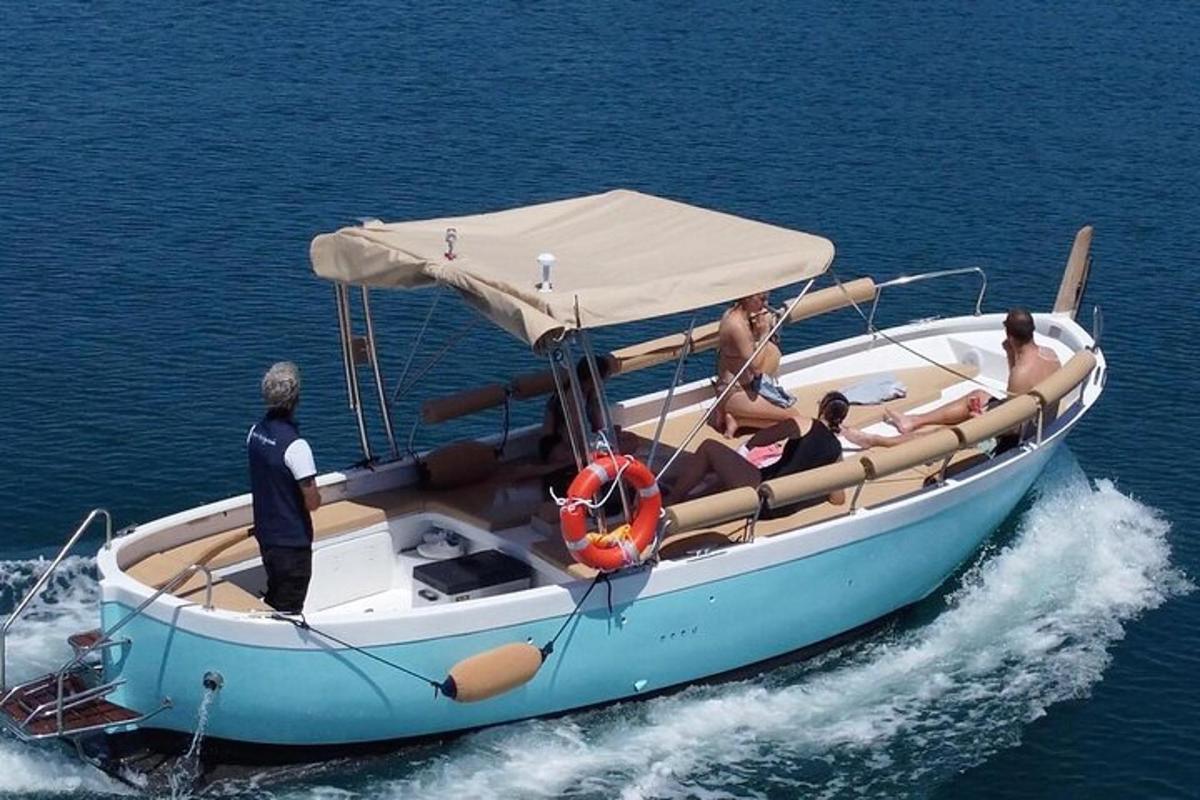 a group of people on a blue boat in the water