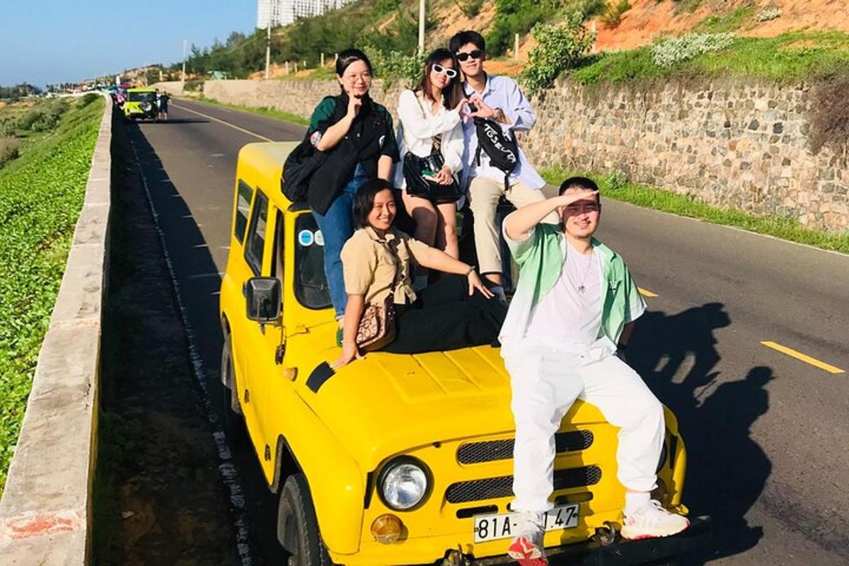 a group of people sitting on the back of a yellow bus