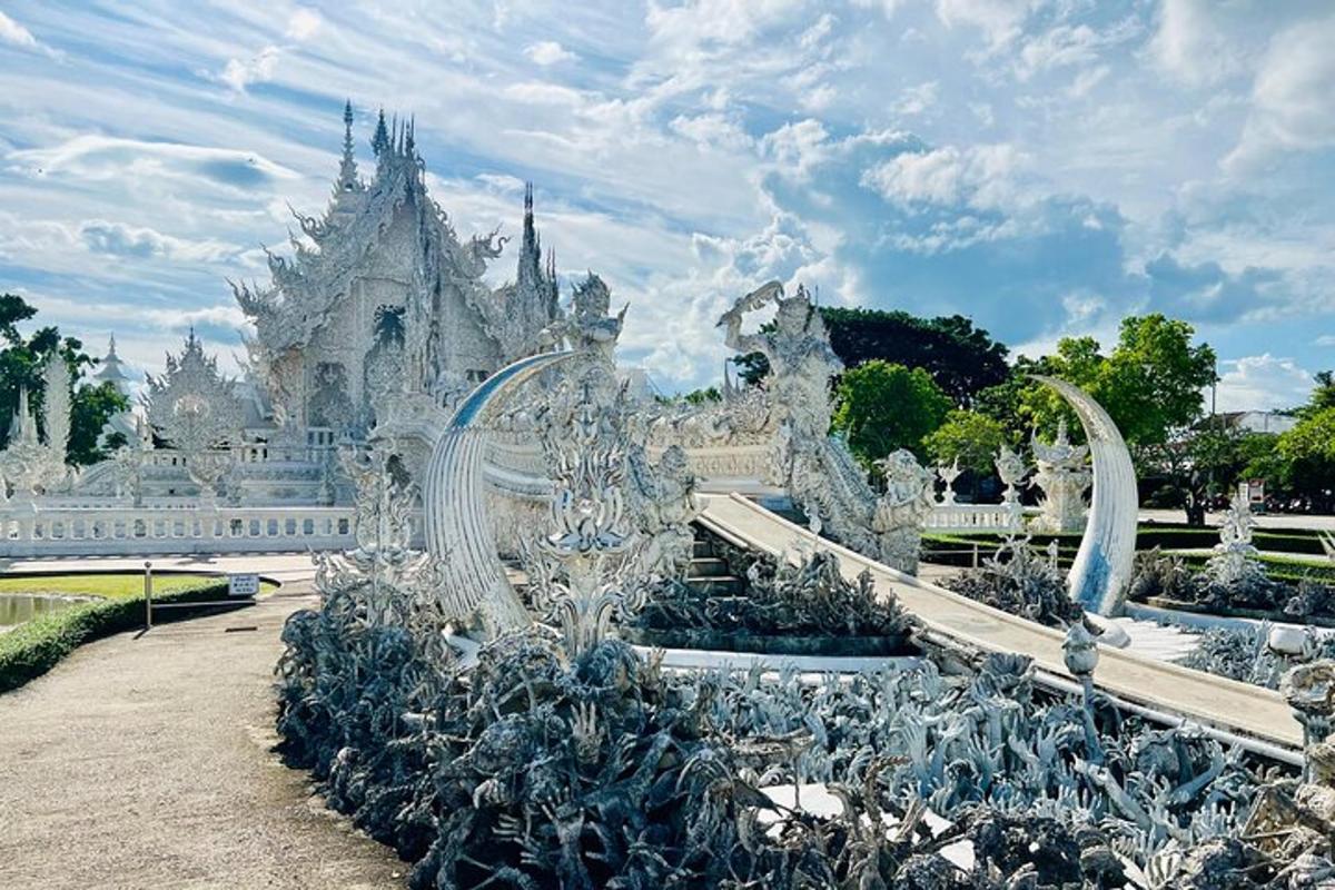 Un edificio blanco con una fuente delante.