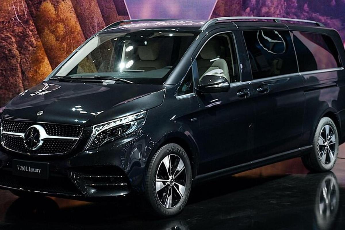 a black car is on display at a show