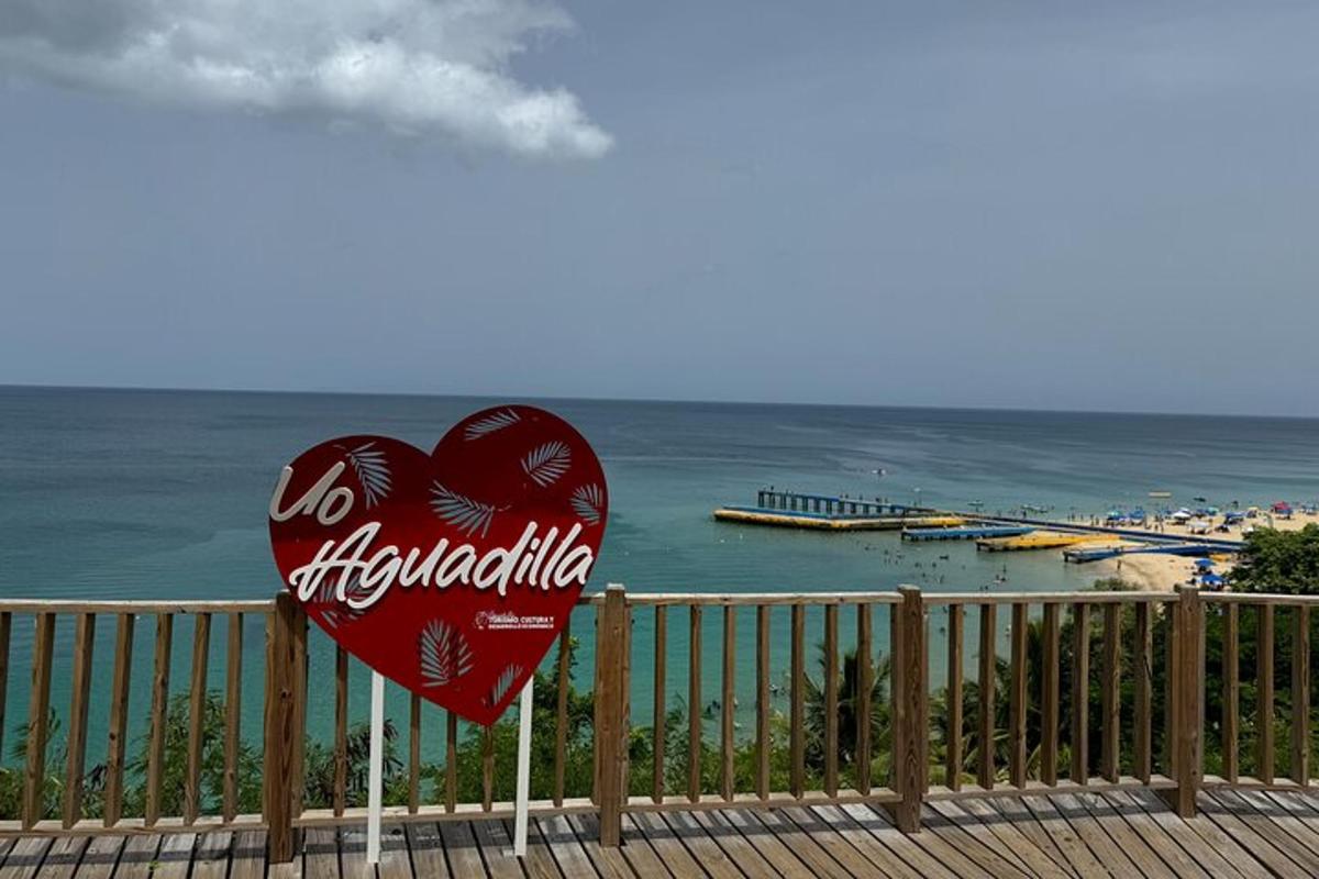 a heart shaped cocacola sign next to a fence