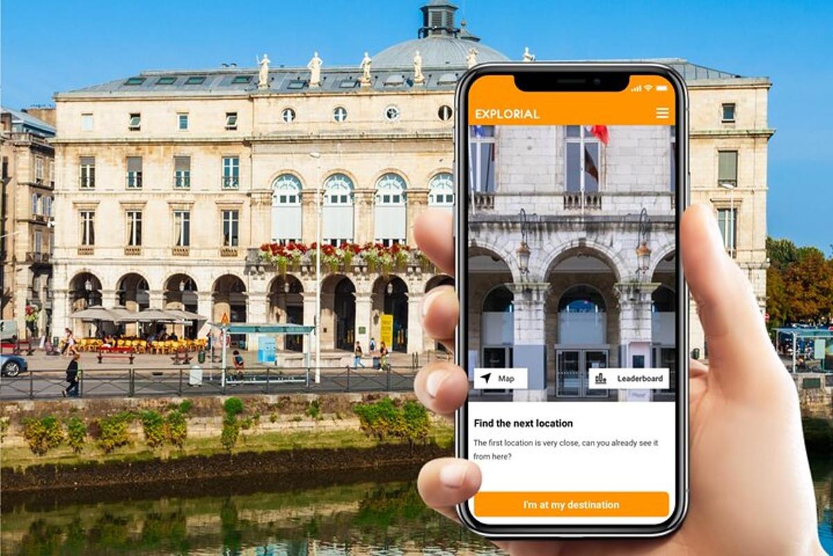 a person holding up a cell phone in front of a building