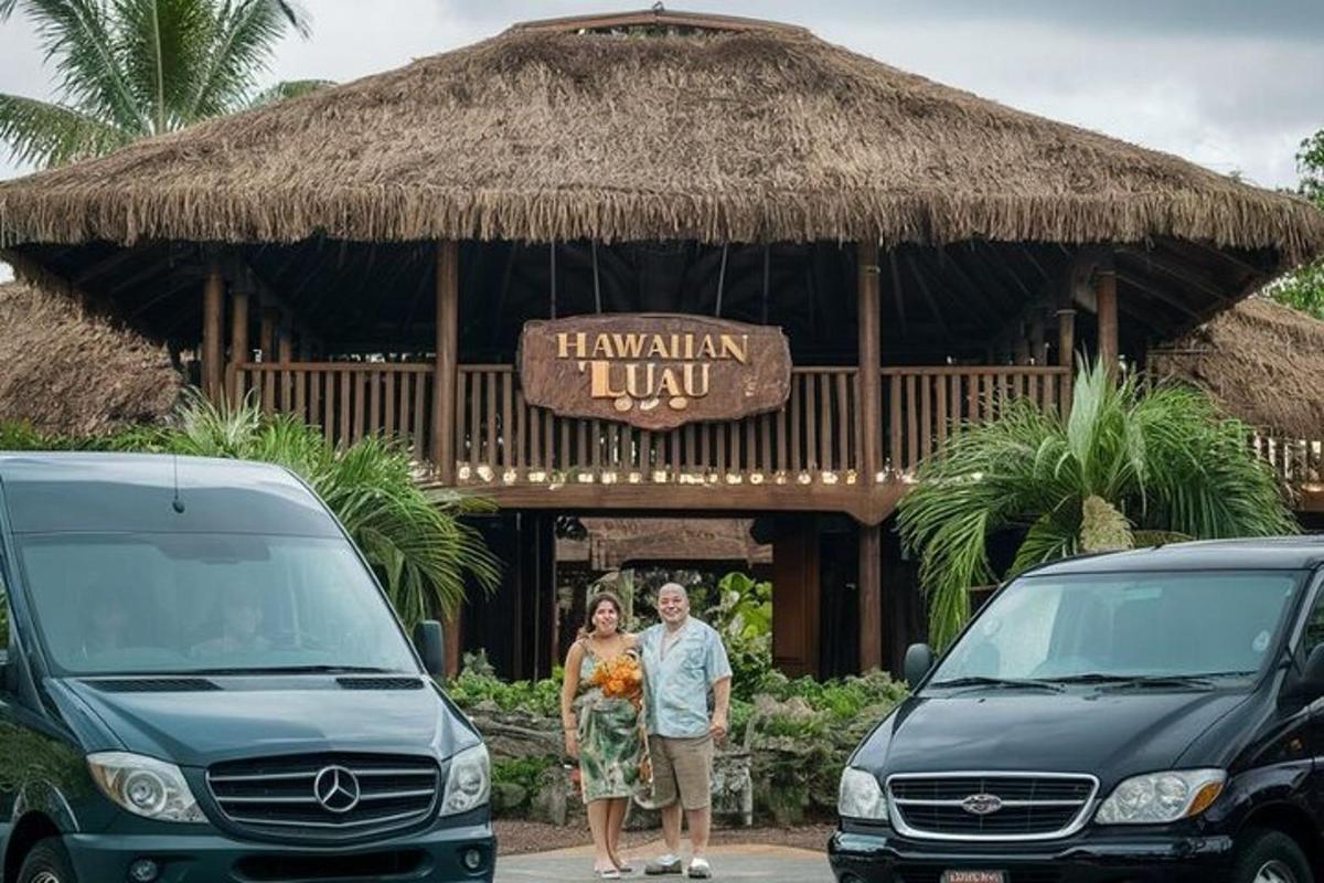 un uomo e una donna in piedi davanti a un hotel con due auto