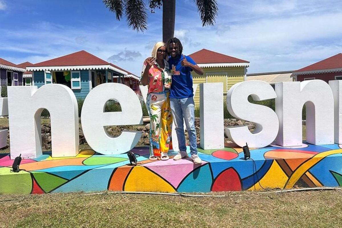 two people standing in front of a sign with a skateboard