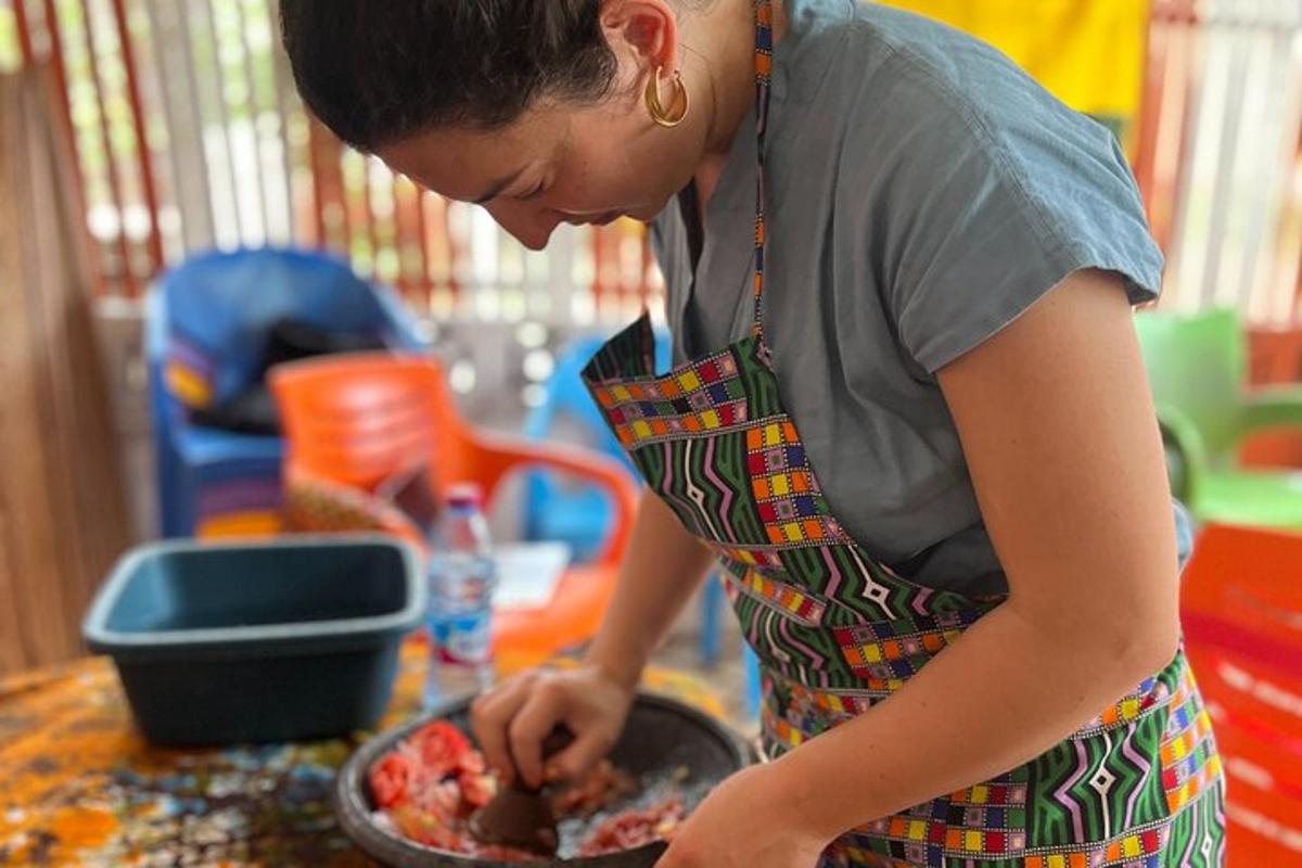 a woman in an apron preparing food in a pan