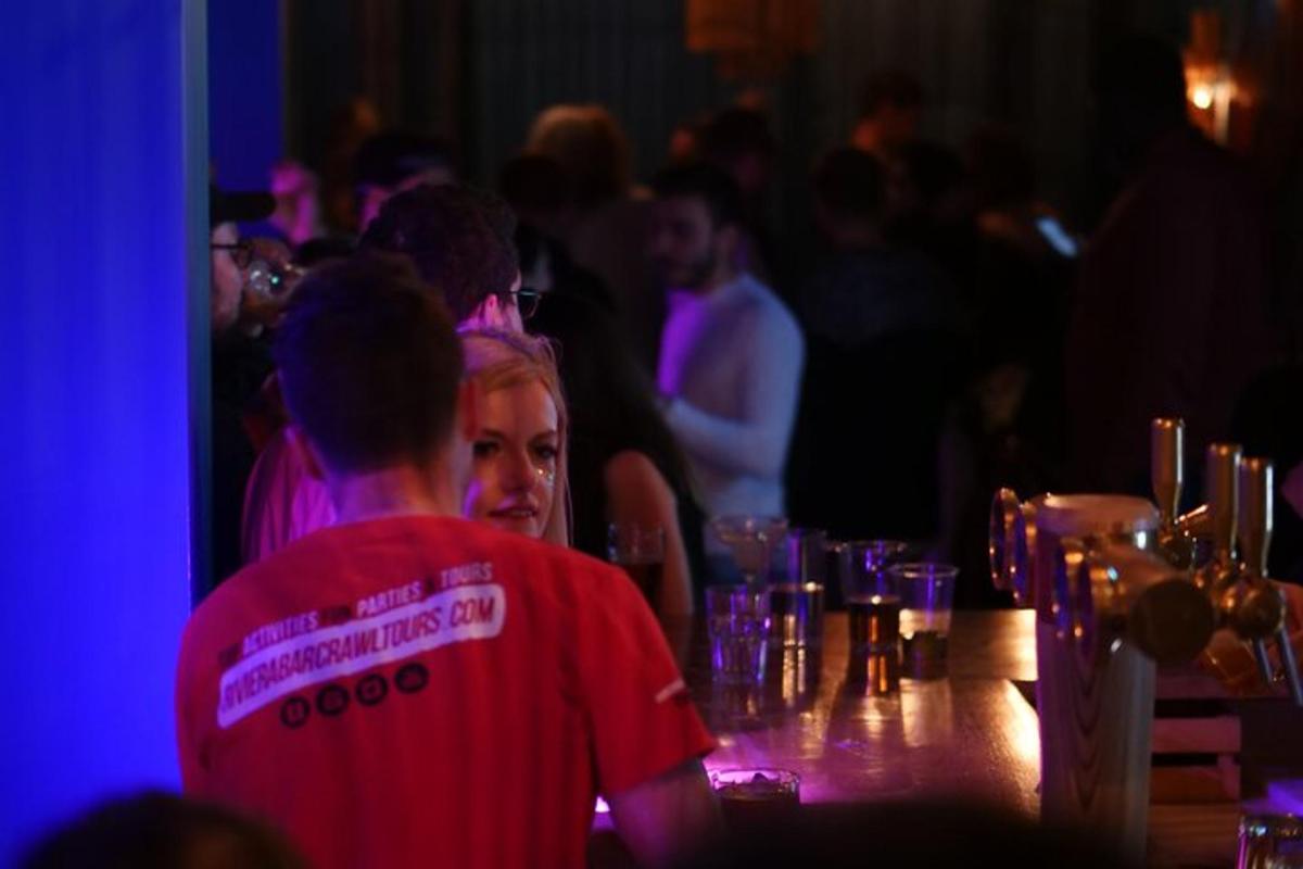 en gruppe mennesker sidder ved en bar med briller