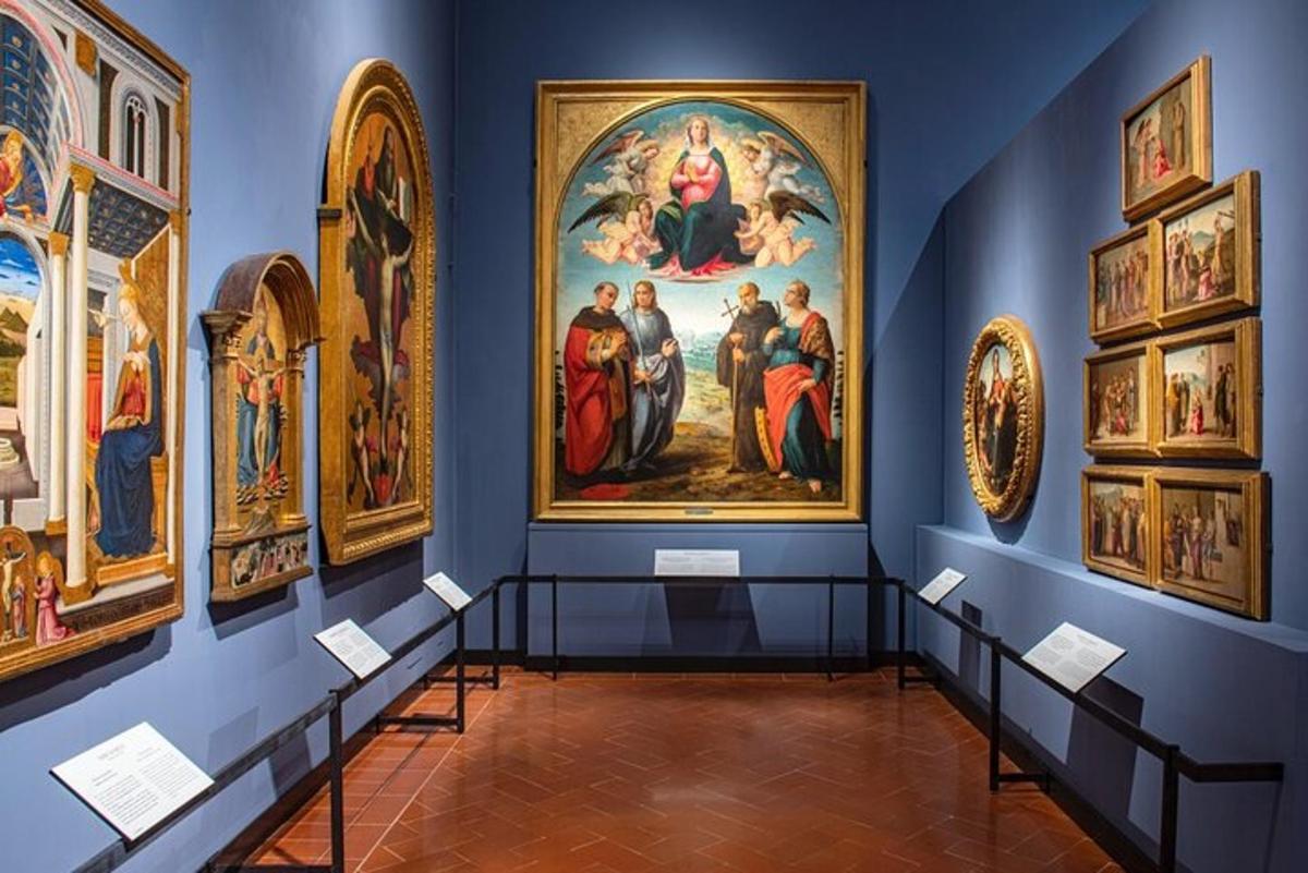 a room with a bunch of paintings on the wall