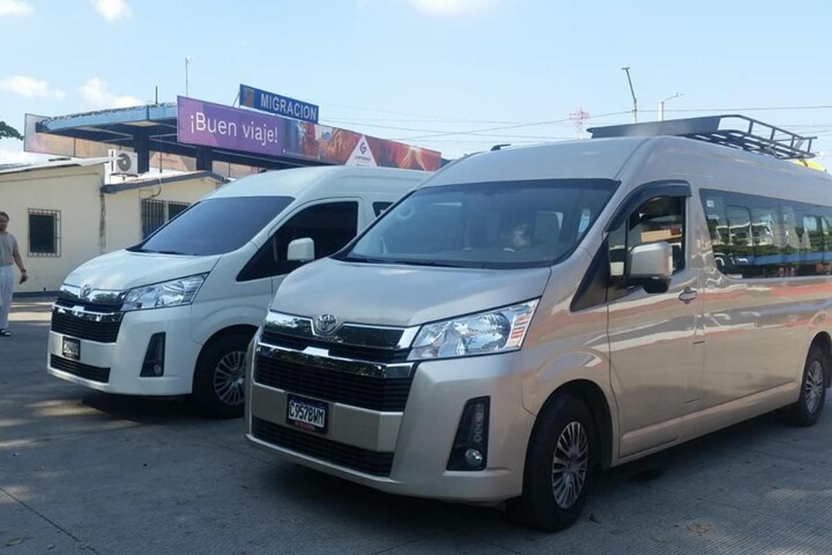 two vans parked next to each other in a parking lot
