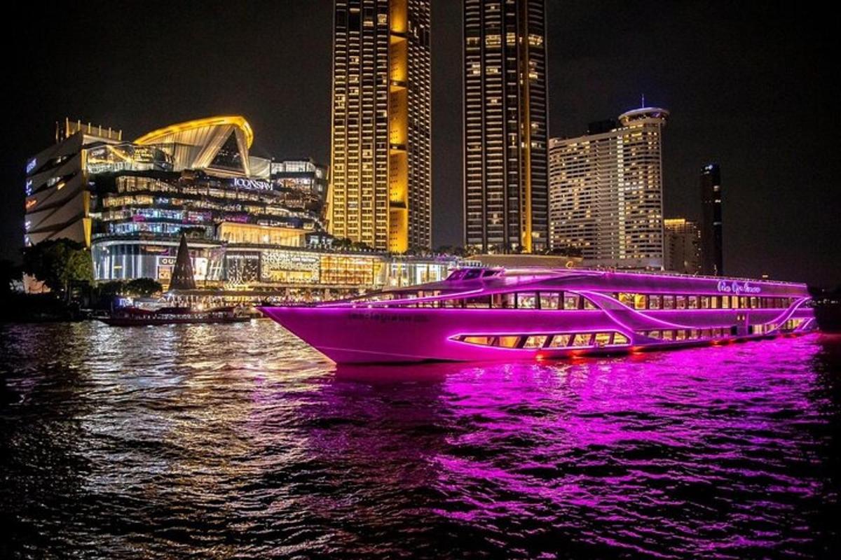 a boat with purple lights on the water at night