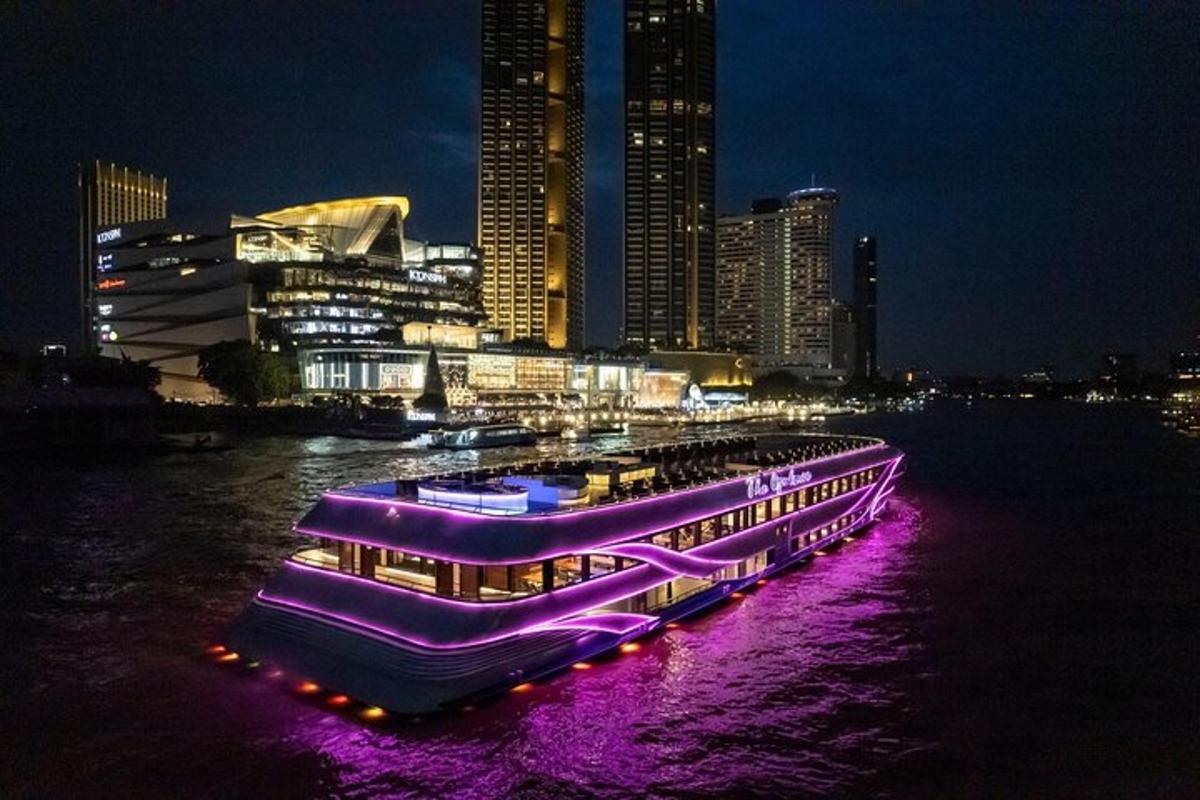 a large purple boat in the water at night