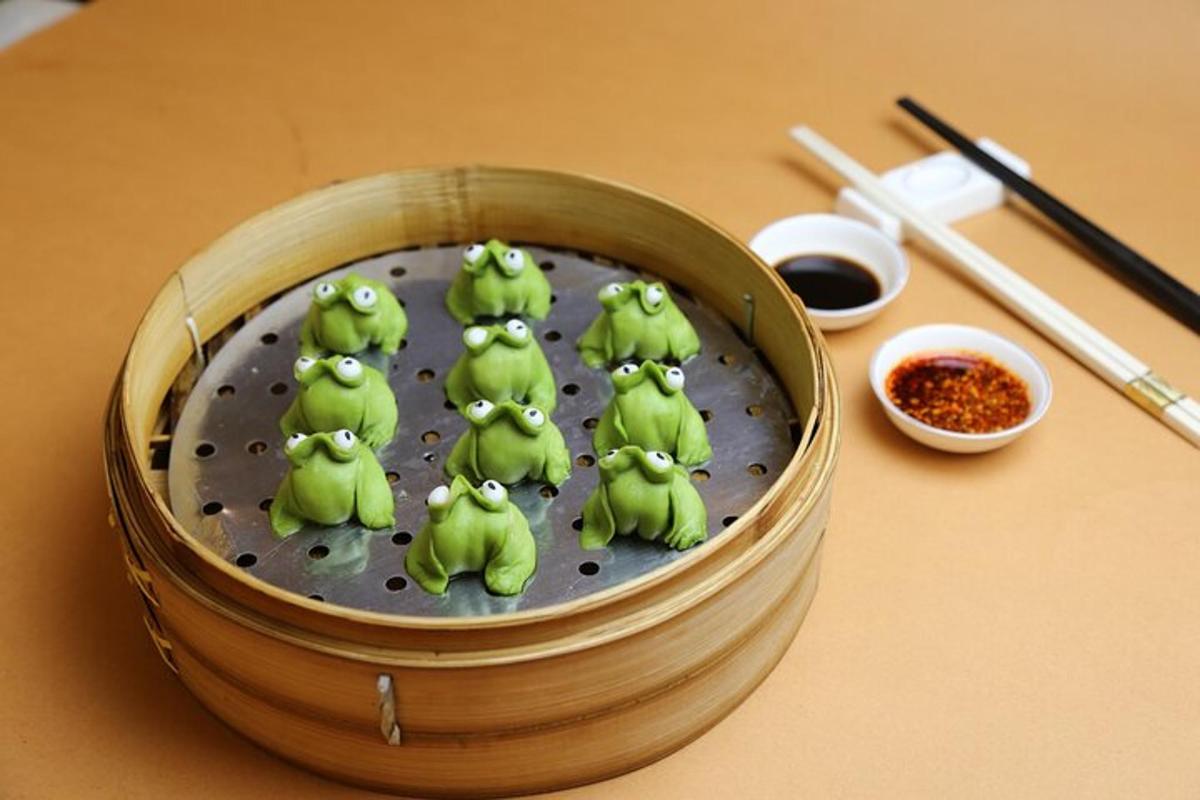 a group of green frogs sitting on top of a tin