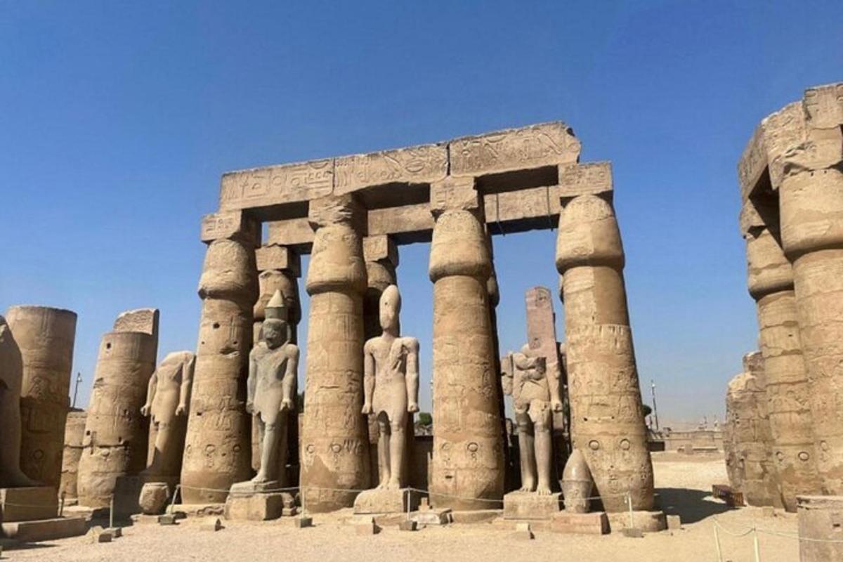 an ancient building with statues in the desert