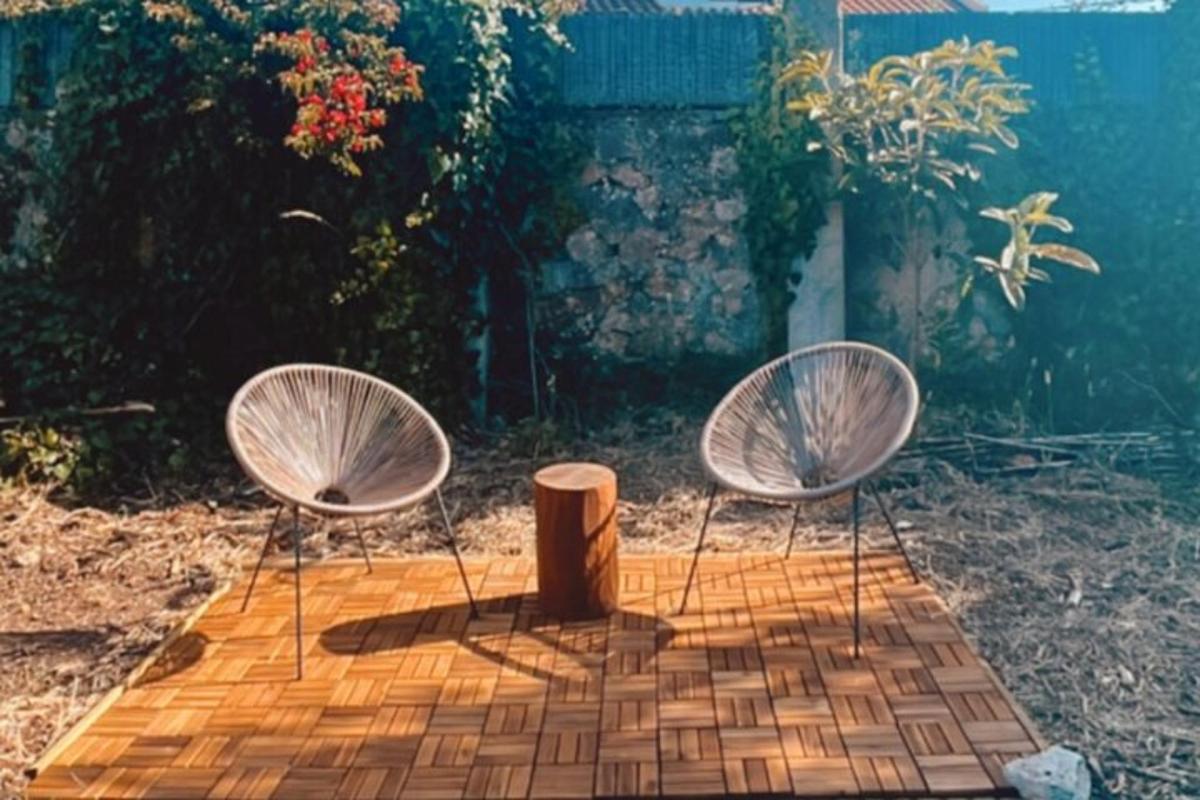 a couple of chairs sitting on top of a patio
