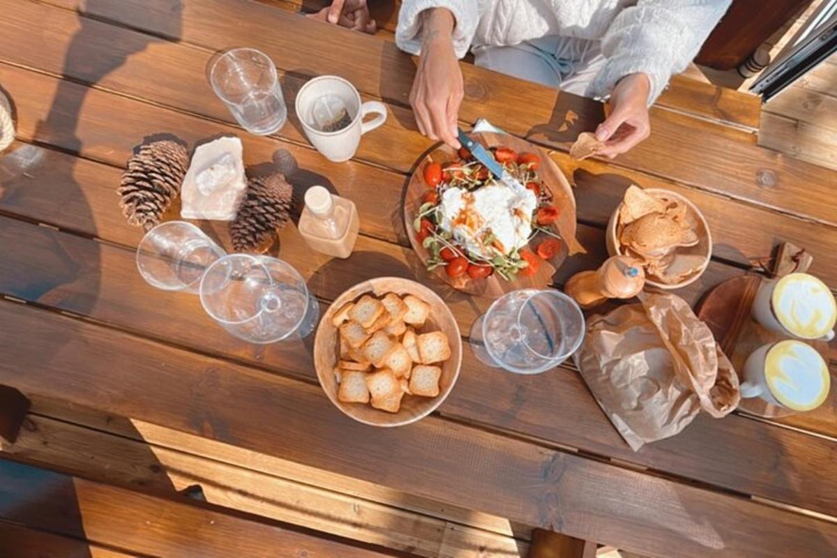 a wooden table with food and drinks on it