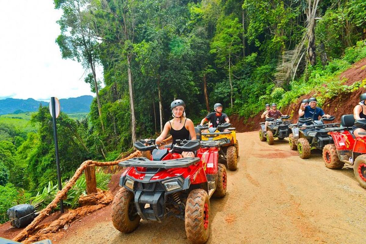 a group of people riding atvs on a dirt road