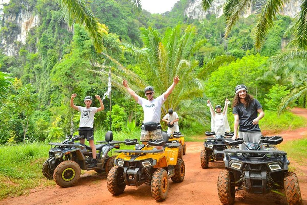a group of people riding atvs on a dirt road