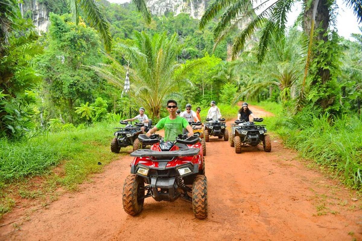 a group of people riding atvs on a dirt road