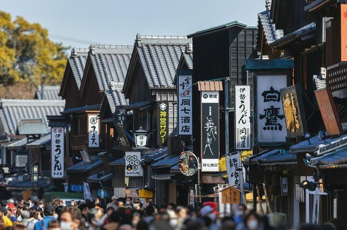 a crowd of people walking down a street with signs