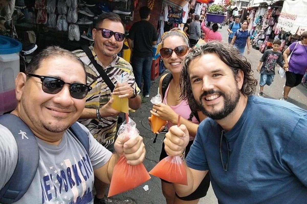 a group of people holding up drinks in plastic bags