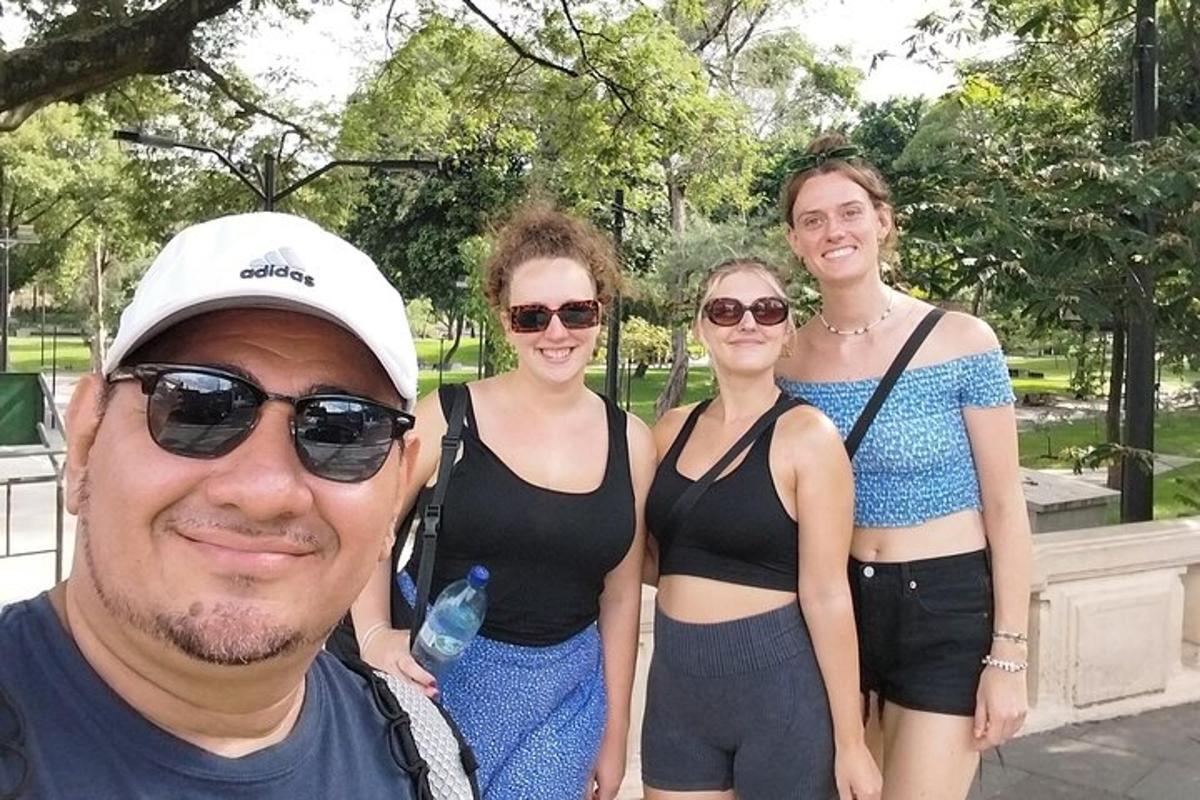 a man and four women standing in a park