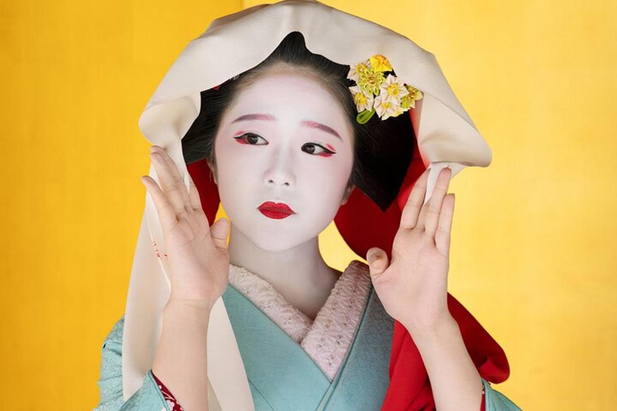 a woman wearing a kimono with a flower in her hair