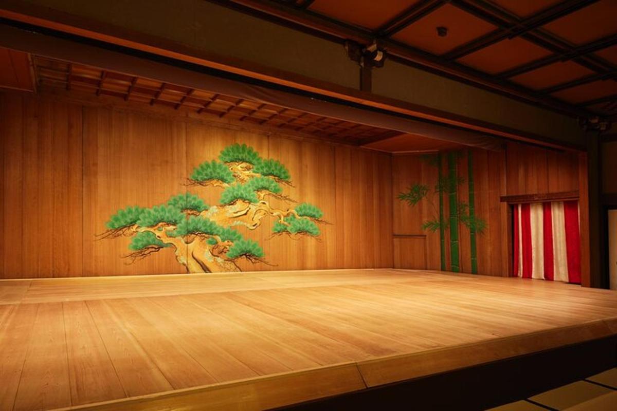 a stage with a tree painting on the wall