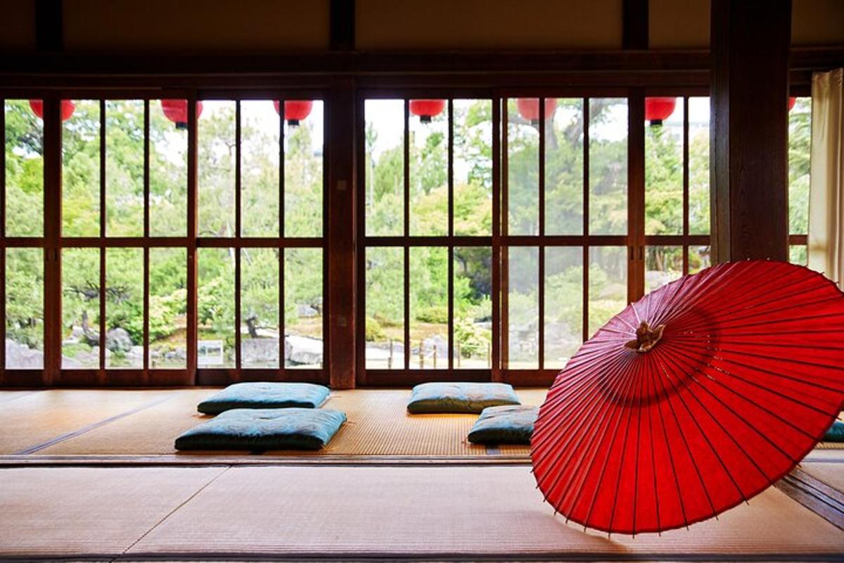 a room with a red umbrella and four pillows