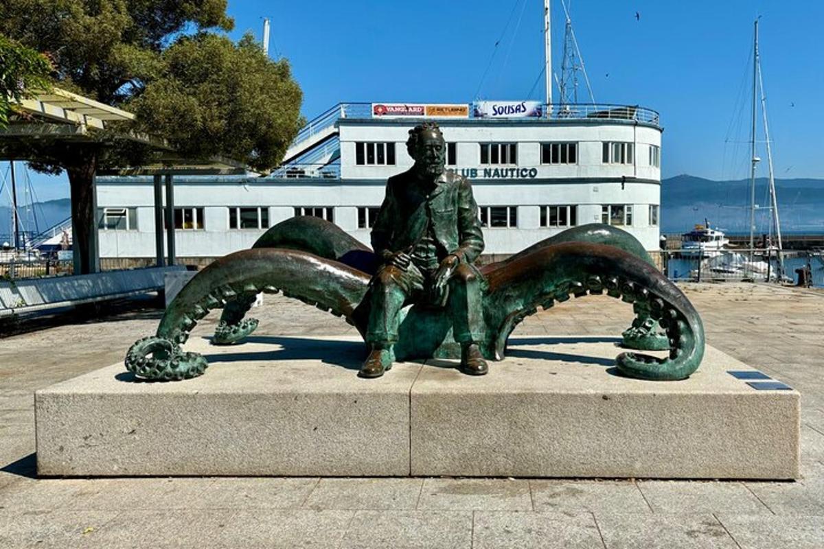 a statue of a man sitting in front of a harbor