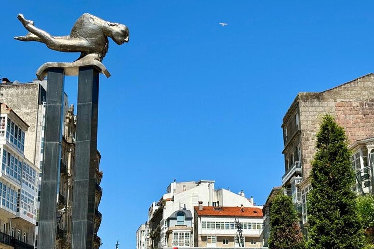 a statue of a dog on a pole in a city