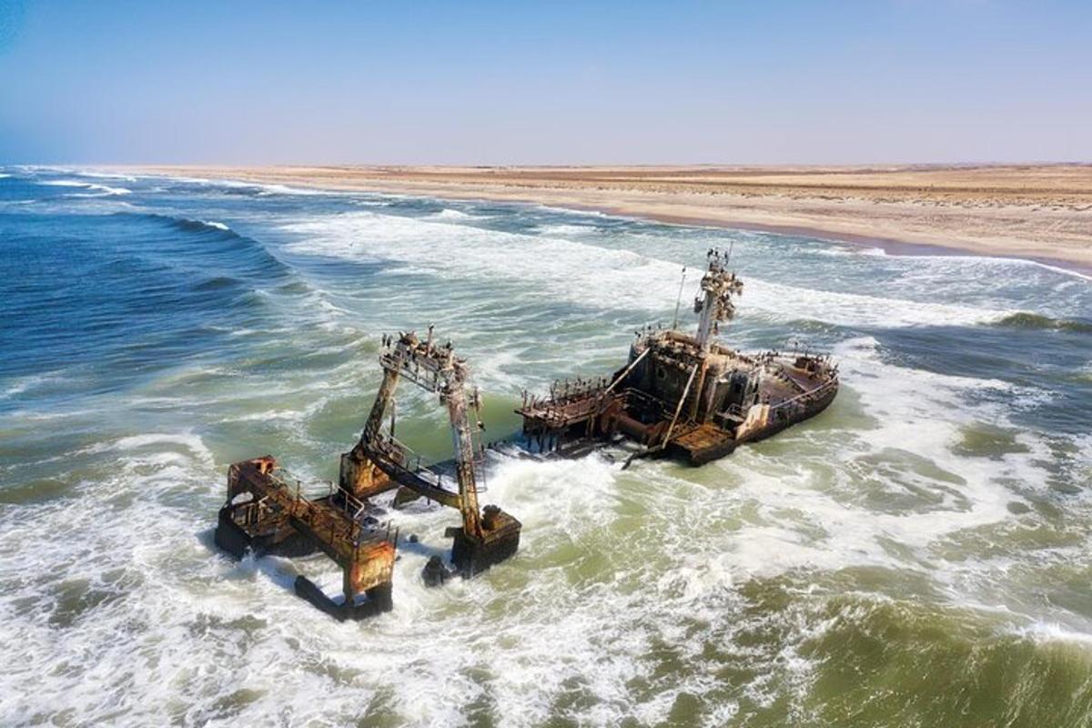 a boat in the ocean with two dredgers in the water