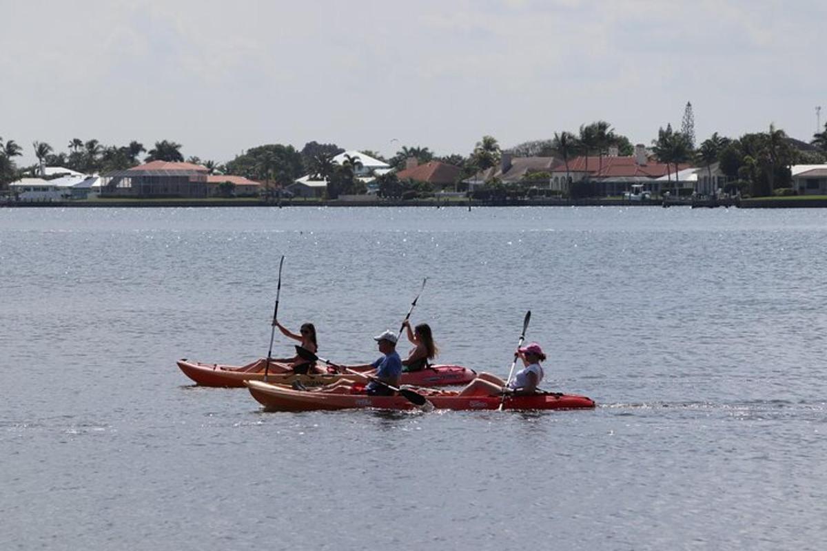 a group of people in kayaks on a lake