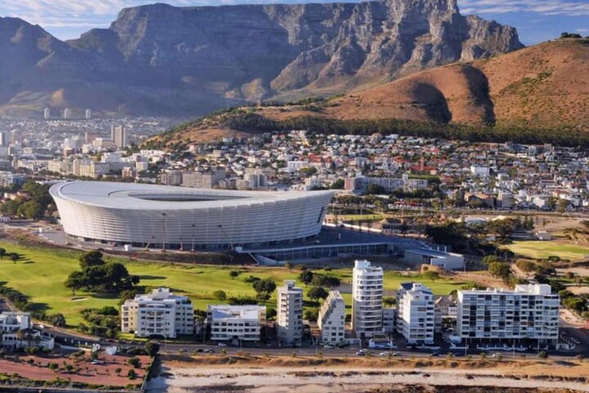 an aerial view of a soccer stadium in front of a mountain