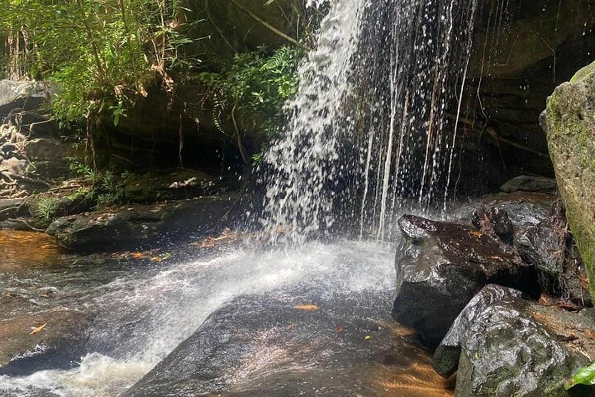 a waterfall in the middle of a pool of water